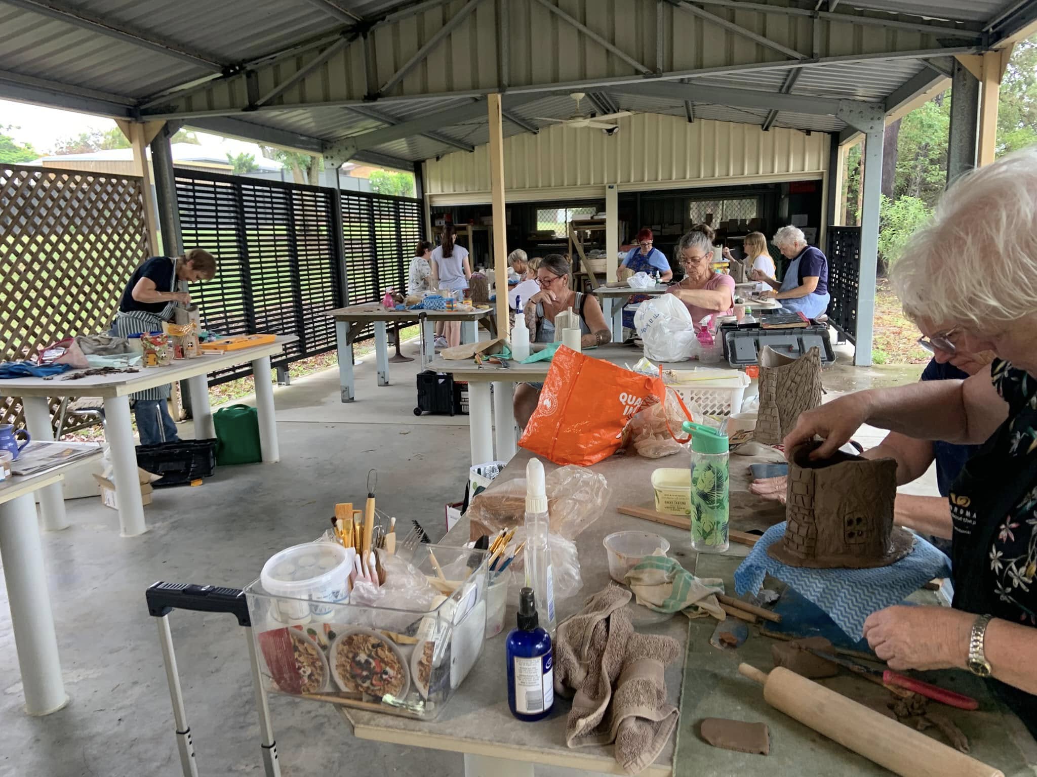 Workshop session with members creating pottery